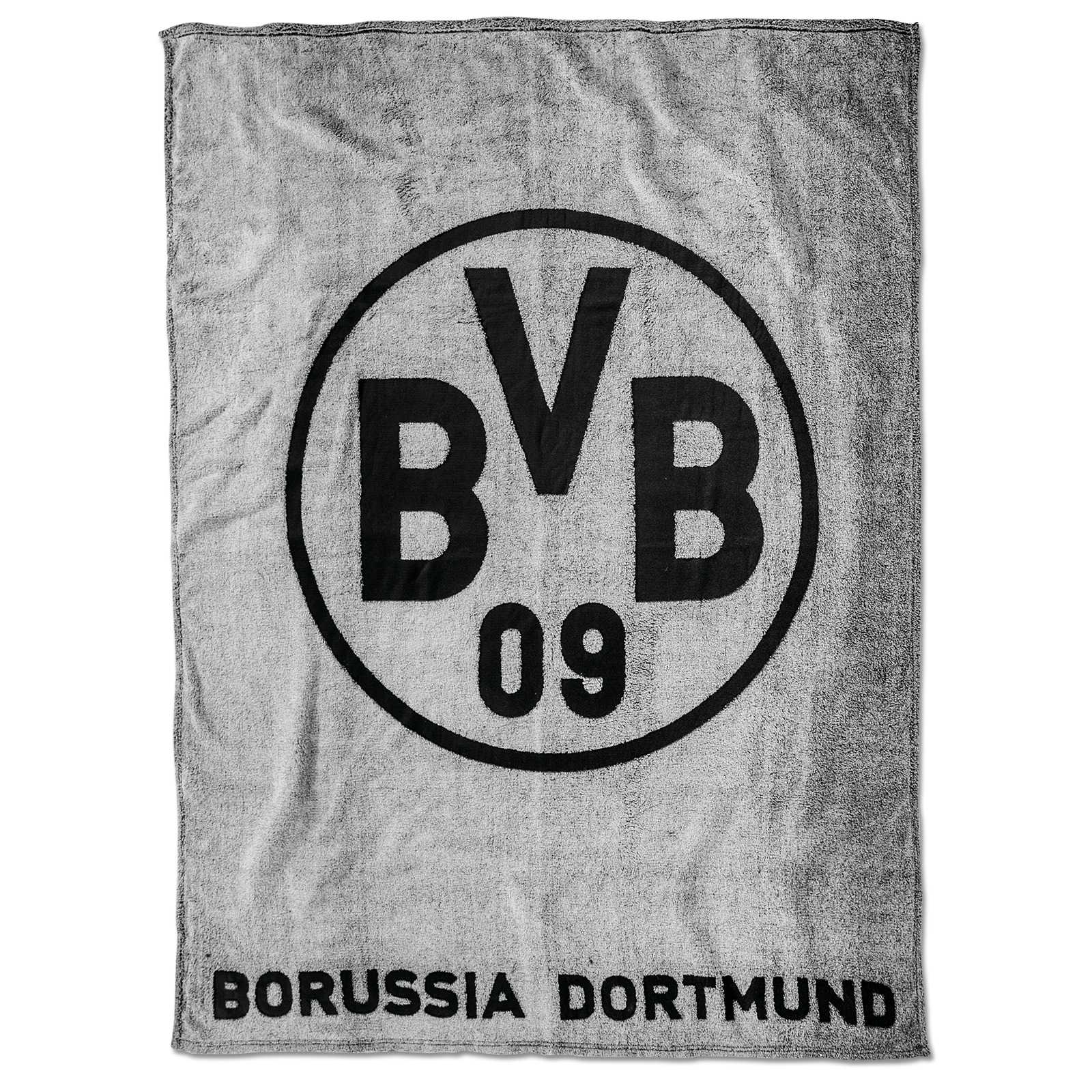 Frontalansicht der BVB-Fleecedecke (grau) mit großem schwarzen BVB-Emblem und dem Schriftzug "Borussia Dortmund" am unteren Rand.